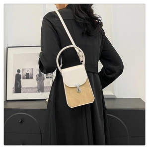 Detail showing contrast patchwork mini bag with silver buckle and suede texture