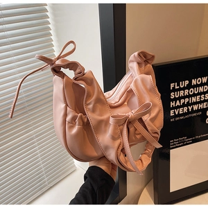 Pink PU leather crescent shoulder bag with cloud-like pleats and decorative bows