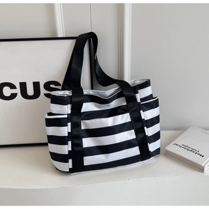 Classic black and white striped tote bag with multiple pockets for daily commuting
