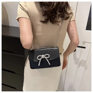 Fashionable black PU leather mini shoulder bag with a silver rhinestone bow detail