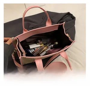 Detailed interior view of a pink PU leather and woven tote bag with daily cosmetics