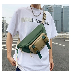 Detail view of a two-tone nylon waist bag with adjustable straps and buckle closures
