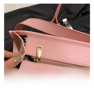 Close-up of premium gold metal zipper and pink PU leather stitching on a crossbody bag