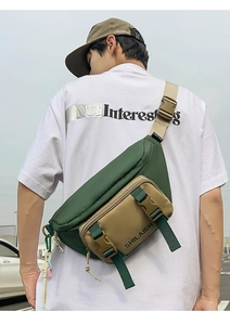 Outdoor shot of a durable forest green and khaki nylon waist bag with adjustable strap