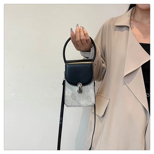 Minimalist summer handbag in silver glitter and black PU leather with round handle