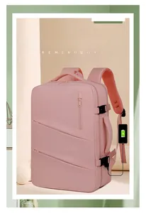 Detail of pink waterproof oxford backpack showing USB charging port and multi-zipper pockets