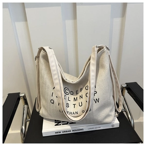 Chic beige canvas tote bag with herringbone texture and black bold typography