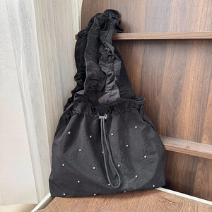Black nylon shoulder bag with sparkling rhinestones and elegant ruffled strap detail