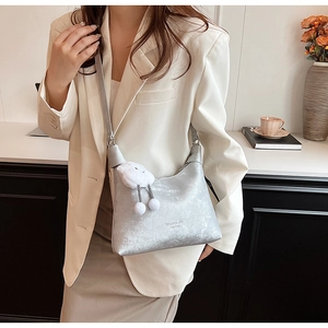 Detail of silver PU leather crossbody bag with cloud charm and minimalist strap