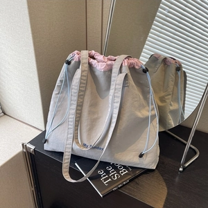 Gray drawstring fabric tote bag with pink trim and My Sunday print for daily use