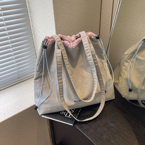 Light gray nylon drawstring tote bag with pink lining and My Sunday logo for women