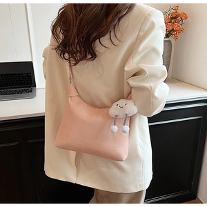 Pink PU leather saddle bag with MINGGAILANDI embossing and white cloud plush charm detail