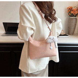 Detail of pink PU leather half-moon crossbody bag with cute cloud plush charm accessory