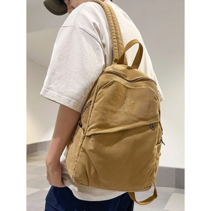 Minimalist khaki canvas backpack for women shown on model for travel and school use