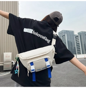 Outdoor model wearing a minimalist beige nylon fanny pack with blue strap and buckle