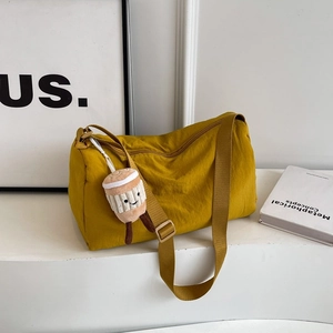 Minimalist ginger nylon crossbody bag with wide adjustable strap and coffee plush charm