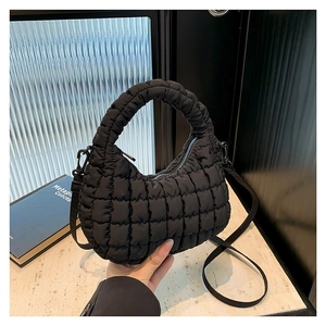 Black quilted puffer handbag with detachable shoulder strap and nylon fabric texture