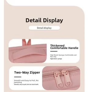 Close-up of comfortable padded pink handle and smooth dual-zipper closure details