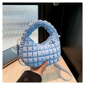 Sky blue quilted puffy crossbody bag with cloud texture and adjustable shoulder strap