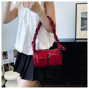 Detail of burgundy PU leather handbag with scrunchie strap and utility cargo pockets
