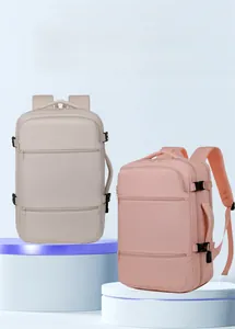 Detail view of two water-resistant oxford backpacks in beige and pink with multiple pockets