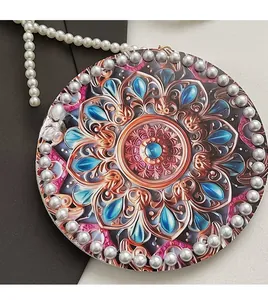 Detailed view of mandala pattern crossbody bag with pearl strap and decorative beads