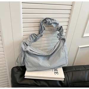 Light blue nylon half-moon shoulder bag with ruched handle and minimalist design