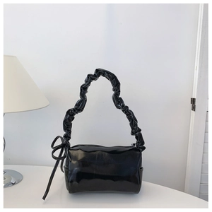 Minimalist black glossy PU shoulder bag featuring a ruched cloud strap and bow detail