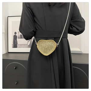 Golden heart-shaped evening clutch bag with sparkling rhinestones and chain strap