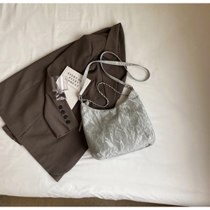Minimalist light gray PU moon bag with metallic pleated texture and chain strap