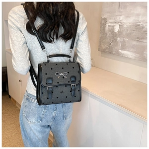Polka dot mini backpack for women featuring grey fabric and silver bow metallic buckle detail