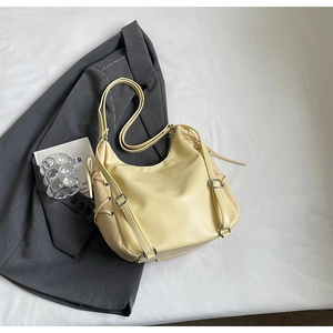 Minimalist light yellow PU leather half-moon crossbody bag with side drawstring details