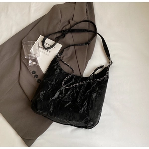 Minimalist black PU leather tote bag with pleated texture and silver chain strap