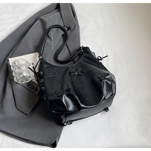 Minimalist black PU crossbody bag with 3D bows and pleated leather texture