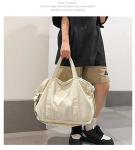 Close-up of a cream canvas tote bag with wide handles for daily casual use