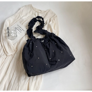 Fashionable black drawstring shoulder bag with silver studs and scrunchie strap detail