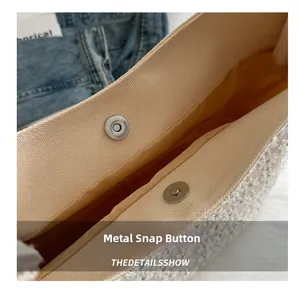 Detail of magnetic hardware clasp on minimalist beige canvas tote bag with textile lining