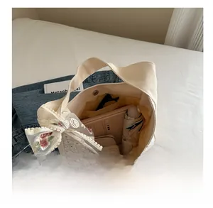 Top view of cream canvas tote bag showing spacious interior with books and umbrella