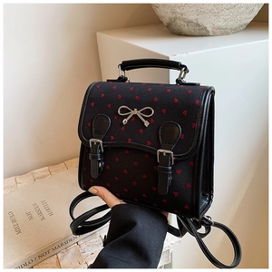 Minimalist black PU backpack with red heart embroidery and silver bow detail for women