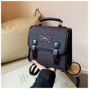 Deep grey PU backpack with red heart patterns and golden bow metal buckle detail