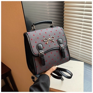 Mini gray backpack with red hearts, black leather trim and metal bow detail