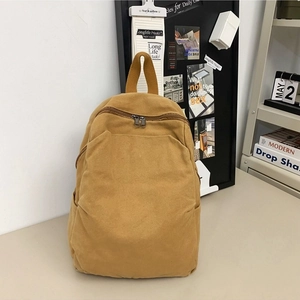 Minimalist mustard yellow canvas backpack for women with top handle and side pockets
