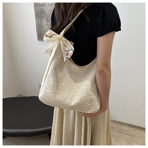 Detail of lace shoulder bag with floral embroidery and large pink flower bow knot