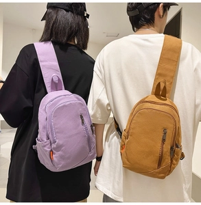 Back view of models wearing lavender and khaki canvas crossbody bags for daily casual use