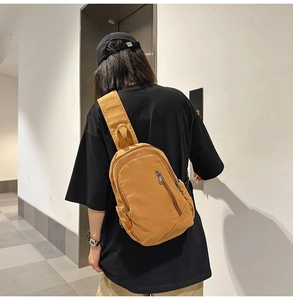 Detail of stylish mustard yellow canvas crossbody bag with adjustable wide strap for women