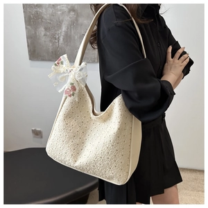 Detail of French floral lace tote bag with delicate pink embroidery and decorative bow