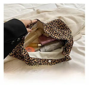 Detail view of leopard print canvas tote bag interior showing large storage capacity