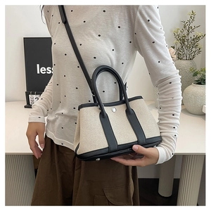 Close-up of the canvas and leather stitching detail on the elegant garden party handbag