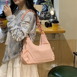 Pink nylon crescent shoulder bag featuring a stylish ruched cloud-style strap detail