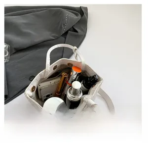 Top view of white crocodile pattern tote bag showing spacious interior with personal items